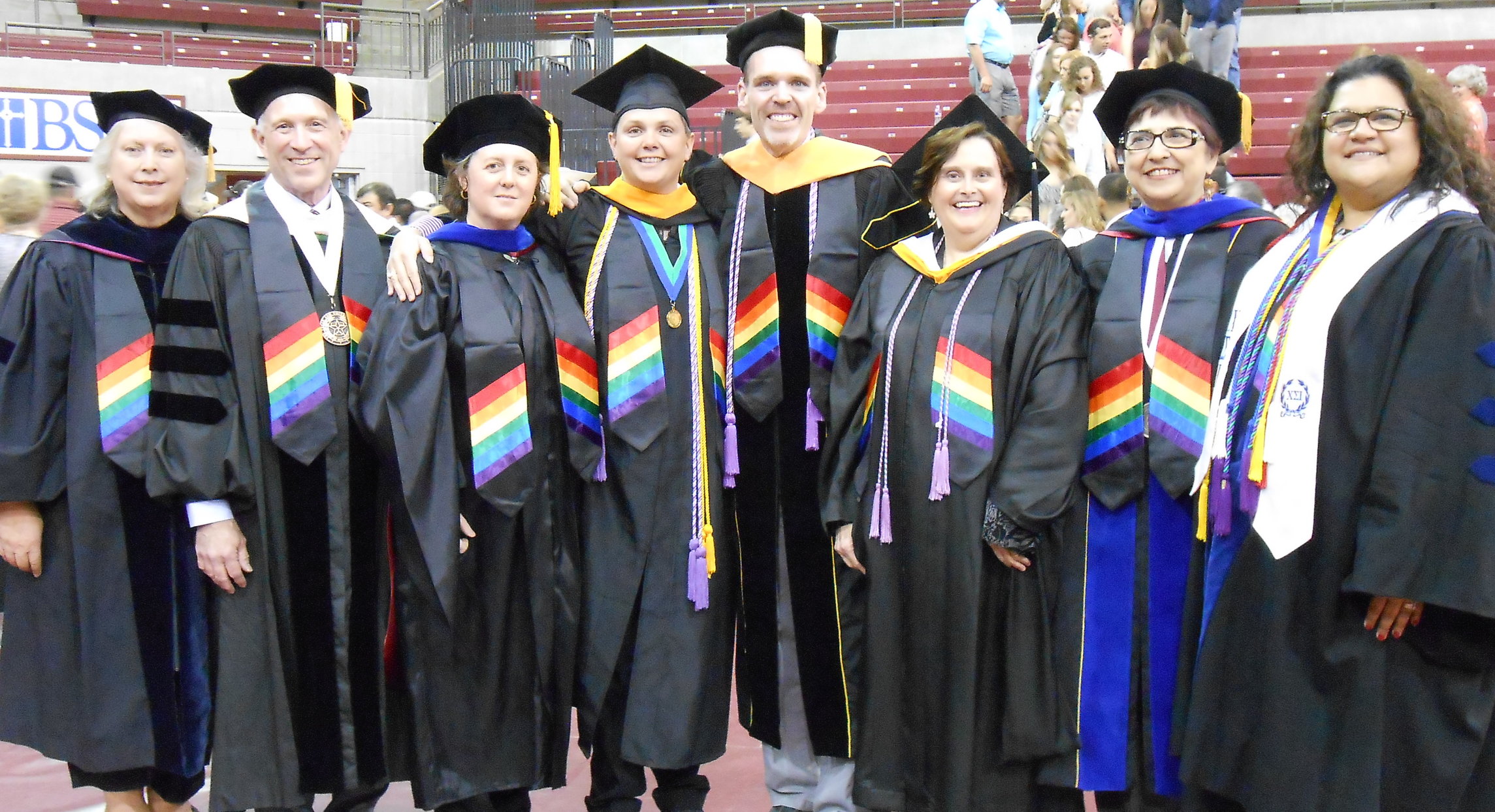 Faculty from Sports Exercise Science, Comm Disorders, and Nursing wearing rainbow stoles. May 2015